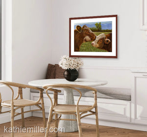 Pastel painting print of a Hereford cow and calf with a mahogany frame and 2” white mat hanging in a contemporary dining room.  Rendered in a realistic style by award winning artist Kathie Miller.