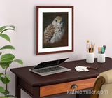 Pastel painting print of an American Kestrel with a mahogany frame and 2” white mat hanging in a home office.  Rendered in a realistic style by award winning artist Kathie Miller.