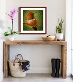 A mock up photo of a rustic entrance hall. Hung on the wall is a print of my painting “A Moment of Rest-Rufus Hummingbird” by award winning artist Kathie Miller. The print has a mahogany frame and white mat. This is a contemporary pastel portrait of a Rufus hummingbird rendered in bold expressive strokes and bright colors. 