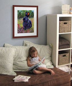 Pastel portrait of a black rabbit sitting among the wildflowers. Print with mahogany frame and a 2” white mat hanging in a childs reading nook.  Rendered in a contemporary style using bold strokes and bright colors by award winning artist Kathie Miller.