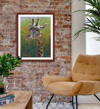 Pastel portrait print of a giraffe in the morning sun with a mahogany frame and 2” white mat hanging in a sitting area. Rendered in a contemporary style using bold strokes and bright colors by award winning artist Kathie Miller. 