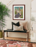 Pastel portrait print of a cute fuzzy donkey framed in mahogany and a white mat  hanging in a Southwest style entrance hall.  Rendered in a contemporary style using bold strokes and bright colors by award winning artist Kathie Miller.