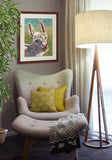 Pastel portrait print of a cute fuzzy donkey framed in mahogany and a white mat  hanging in a corner sitting area.  Rendered in a contemporary style using bold strokes and bright colors by award winning artist Kathie Miller.
