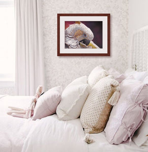 Pastel portrait print of a white cockatoo with a mahogany frame and 2: white mat hanging in a yourng girls bedroom. Rendered in a contemporary style using bold strokes and bright colors by award winning artist Kathie Miller