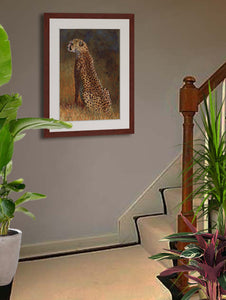 Pastel portrait of a cheetah in the morning light. Print with mahogany frame and a white mat  hanging on a stair landing.  Rendered in a contemporary style using bold strokes and bright colors by award winning artist Kathie Miller.