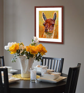 Pastel portrait of an alpaca in a small dining room.  Rendered in a  contemporary style using bold strokes and bright colors by award winning artist Kathie Miller.