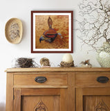 Pastel portrait print of a hooded golden eagle with a mahogany frame and 2” white mat hanging over a cradenza with natural elemets. Rendered in a contemporary style using bold strokes and bright colors by award winning artist Kathie Miller. 
