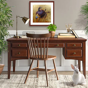 Pastel portrait print of a hooded Harris hawk with a mahogany frame and 2” white mat hanging in a home office. Rendered in a contemporary style using bold strokes and bright colors by award winning artist Kathie Miller. 