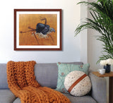 Pastel portrait print of a hooded red tail hawk with a mahogany frame and 2” white mat hanging in living room corner. Rendered in a contemporary style using bold strokes and bright colors by award winning artist Kathie Miller. 