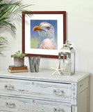 A mock up photo of a cabinet with beach decor. Hung on the wall is a print of my painting “Johnny-Sea Gull” by award winning artist Kathie Miller. The print has a mahogany frame and white mat. This is a contemporary pastel portrait of a sea gull rendered in bold expressive strokes and bright colors. 