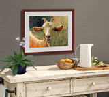 Pastel portrait print of a goat among the flowers framed in mahogany and a white mat  hanging over a country side bar.  Rendered in a contemporary style using bold strokes and bright colors by award winning artist Kathie Miller.