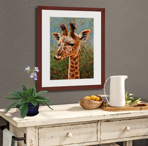A mock up photo of kitchen sidebar. Hung on the wall is a print of my painting “Mandy-Baby Giraffe” by award winning artist Kathie Miller. The print has a mahogany frame and white mat. This is a contemporary pastel portrait of a baby giraffe rendered in bold expressive strokes and bright colors. 