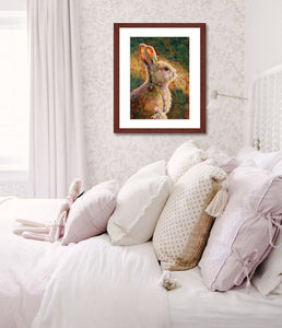 A mock up photo of an girls bedroom. Hung on the wall is a print of my painting “Mocha - Rabbit” by award winning artist Kathie Miller. The print has a mahogany frame and white mat. This is a contemporary pastel portrait of a rabbit rendered in bold expressive strokes and bright colors. 