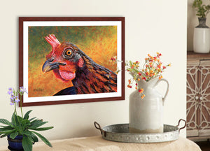Pastel portrait print of a Welsummer hen with a mahogany frame and 2” white mat hanging in a country kitchen. Rendered in a contemporary style using bold strokes and bright colors by award winning artist Kathie Miller. 