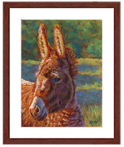 Pastel portrait print of a donkey in the sun with a mahogany frame and 2” white mat. Rendered in a contemporary style using bold strokes and bright colors by award winning artist Kathie Miller. 