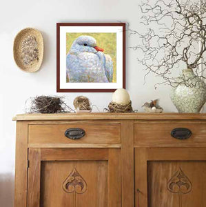 Pastel portrait print of a white dove framed in mahogany and a white mat  hanging over a cradenza with natural elements.  Rendered in a contemporary style using bold strokes and bright colors by award winning artist Kathie Miller.