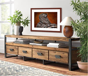 Pastel portrait print of zebra framed in mahogany and a white mat  hanging over a rustic cradenza.  Rendered in a contemporary style using bold strokes by award winning artist Kathie Miller.