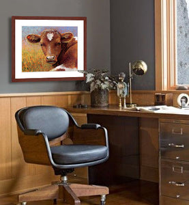 Pastel portrait print of a longhorn calf with a perfect heart on her forehead laying in the sun framed in mahogany and a white mat  in a masculine office.  Rendered in a contemporary style using bold strokes and bright colors by award winning artist Kathie Miller.
