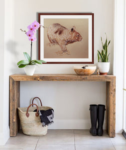 Wombat drawing with mahogany frame hanging in a rustic entrance hall by award winning artist Kathie Miller